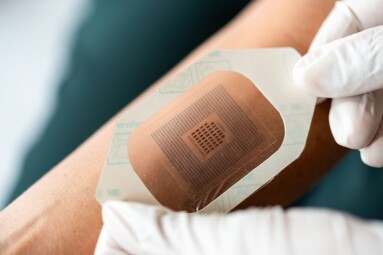 Close-up,Of,Gloved,Hands,Applying,A,Medical,Adhesive,Patch,To