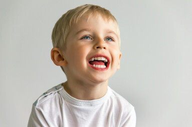 Cheerful,Boy,Laughing,Showing,White,Teeth,,Very,Soft,Focus