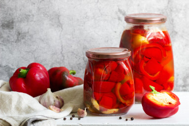 Pickled,Sweet,Peppers,In,Glass,Jars,On,A,Light,Surface.
