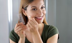 Close-up,Of,Smiling,Girl,Applying,Acne,Treatment,Anti-pickel,Patch,On