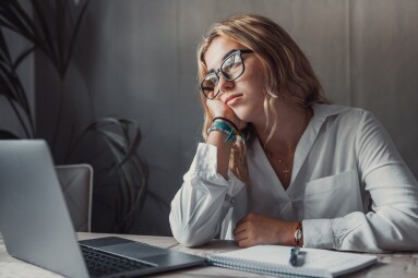 Discontented,Thoughtful,Woman,With,Hand,Under,Chin,Bored,At,Work,