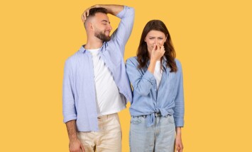 Man,Humorously,Sniffs,His,Armpit,And,Smiles,,While,Woman,Next