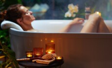 A,Woman,With,A,Bun,Relaxes,In,A,Steam-filled,Bathtub,