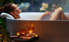 A,Woman,With,A,Bun,Relaxes,In,A,Steam-filled,Bathtub,
