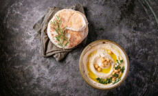 Home,Made,Hummus,Bowl,,Decorated,With,Boiled,Chickpeas,,Herbs,,Pita