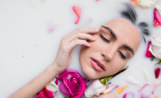 Sensual,Woman,Touching,Face,While,Taking,Milk,Bath,With,Rose