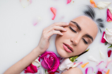 Sensual,Woman,Touching,Face,While,Taking,Milk,Bath,With,Rose