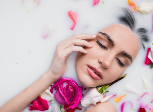 Sensual,Woman,Touching,Face,While,Taking,Milk,Bath,With,Rose