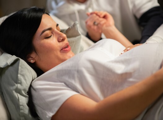 Dark-haired,Woman,Giving,Birth,At,Home.,Woman,With,Pierced,Nose