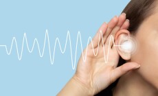 A,Woman,Puts,Her,Hand,To,Her,Ear,And,Listens,