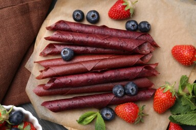 Tasty,Fruit,Leather,Rolls,,Strawberries,,Blueberries,And,Mint,On,Grey