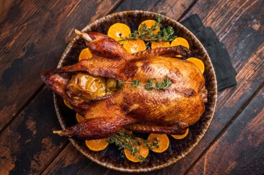 Roast,Goose,With,Apples,And,Oranges,On,Plate,With,Herbs.