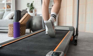 Sporty,Woman,Jogging,On,Treadmill,At,Home,,Back,View