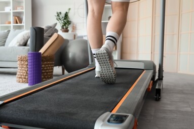 Sporty,Woman,Jogging,On,Treadmill,At,Home,,Back,View