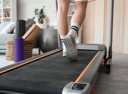 Sporty,Woman,Jogging,On,Treadmill,At,Home,,Back,View