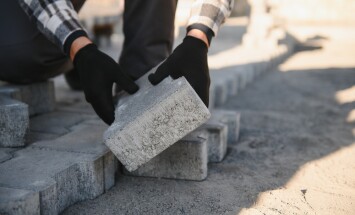 Builder,Laying,A,Paving,Brick,Placing,It,On,The,Sand
