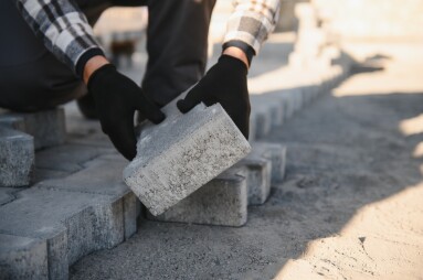 Builder,Laying,A,Paving,Brick,Placing,It,On,The,Sand