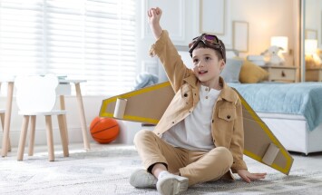 Smiling,Little,Boy,With,Cardboard,Plane,Wings,And,Goggles,Playing