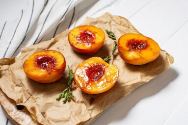 Baked,Peaches,With,Honey,And,Cinnamon,On,White,Wooden,Background.