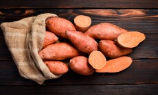 Bag,Of,Raw,Sweet,Potatoes,On,Wooden,Background.,Autumn,Vegetables,