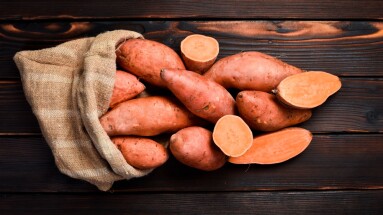 Bag,Of,Raw,Sweet,Potatoes,On,Wooden,Background.,Autumn,Vegetables,