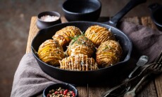 Baked,Hasselback,Potatoes,With,Cheese,,Garlic,And,Greens