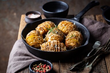 Baked,Hasselback,Potatoes,With,Cheese,,Garlic,And,Greens