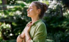 Woman,With,Closed,Eyes,And,Arms,On,Chest,Practicing,Mindfulness