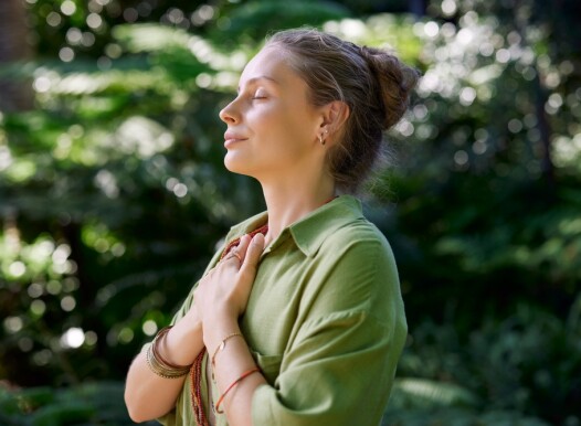 Woman,With,Closed,Eyes,And,Arms,On,Chest,Practicing,Mindfulness