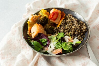 A,Quinoa,Bowl,Is,Filled,With,Baked,Salmon,,Broccoli,,Tomatoes,