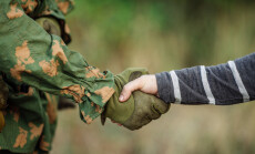 Soldier,Shaking,Hands,With,Civil,Man,On,Outdoor,Background