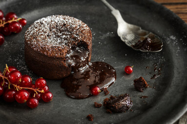 Warm,Chocolate,Lava,Cake,With,Bite,Taken,Out,Of,Molten